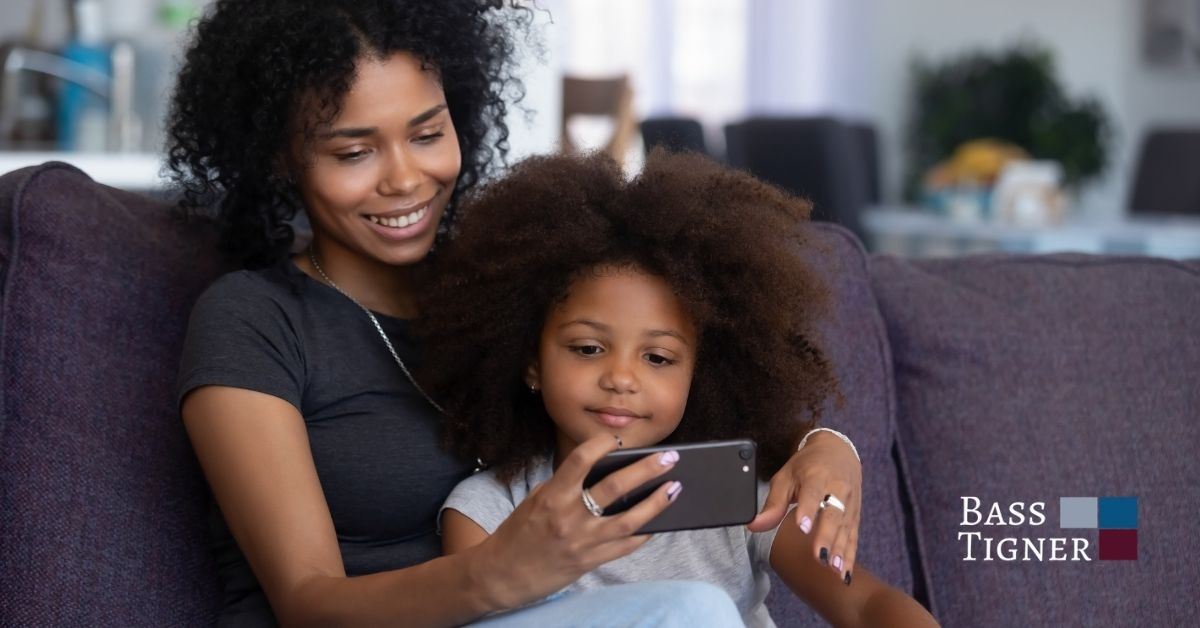 Mom and daughter looking at phone.