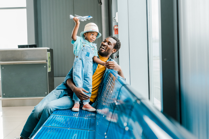father and child in an airport