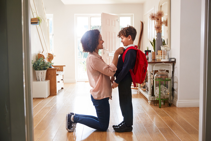mother helping child prepare for school