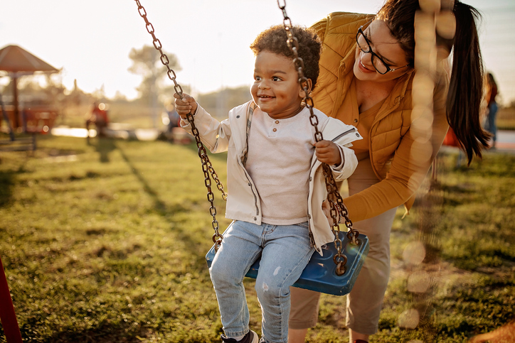 mother and son playing on the swing