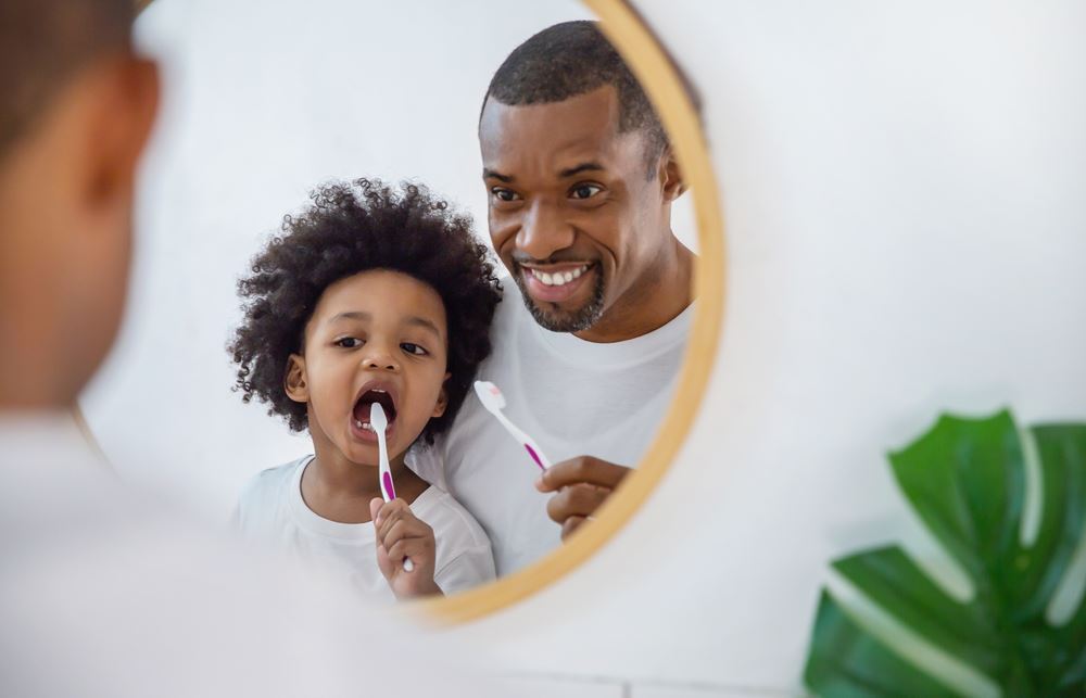 father and son child boy brushing teeth in the bathroom
